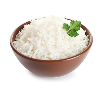 Bowl of tasty cooked rice with parsley on white background