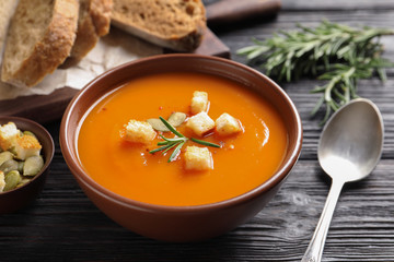 Bowl of tasty sweet potato soup served on table