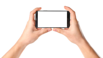 Man holding smartphone with blank screen on white background, closeup of hands. Space for text