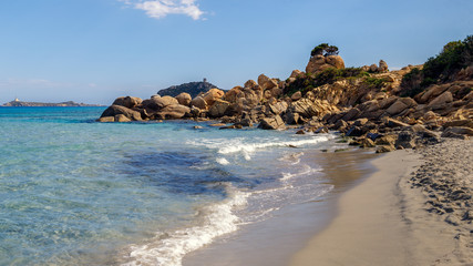 Fototapeta na wymiar Panoramic view of sandy beach, rocks and sea with azure water, in Villasimius, Sardinia (Sardegna) island, Italy. Holidays, best beaches in Sardinia.