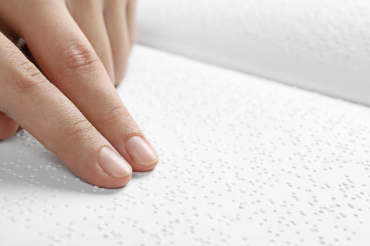 Blind person reading book written in Braille, closeup