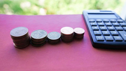 Stack of coins and calculator,concept idea for business finance and education. Financial accounting, money calculator 