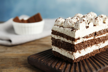 Tiramisu cake on table, closeup. Space for text
