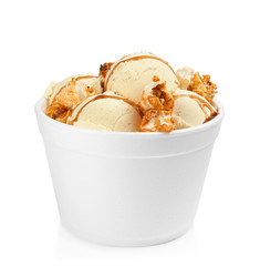 Delicious ice cream with caramel popcorn and sauce in dessert bowl on white background