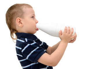 Child drinks milk from a bottle on a white background