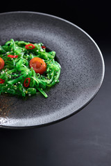 Chuk salad on a black plate