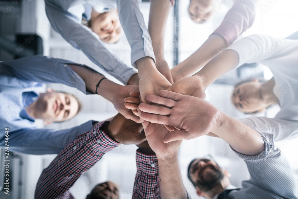 Wall mural stack of hands. unity and teamwork concept.