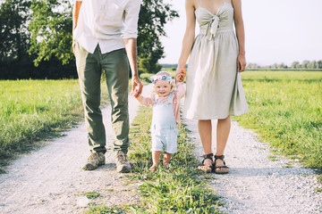 Family on nature. Mother and father with baby outdoors.