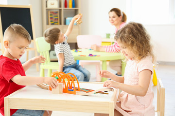 Cute little children playing in kindergarten