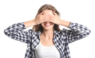 Young woman covering her eyes on white background