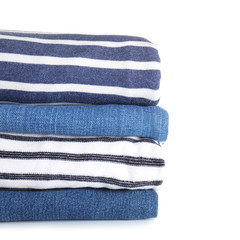 Stack of modern clothes on white background