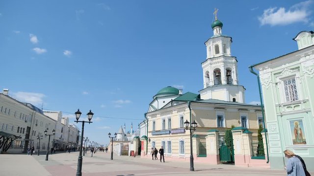 View of the city center and people walking on the street with Kul Sharif mosque on the background in summer day. Stock footafe. Kazan city, Tatarstan republic
