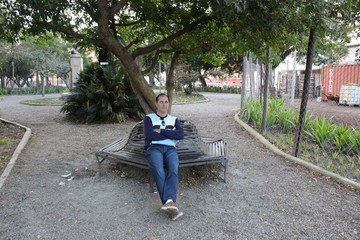 young man sitting on a bench in the park