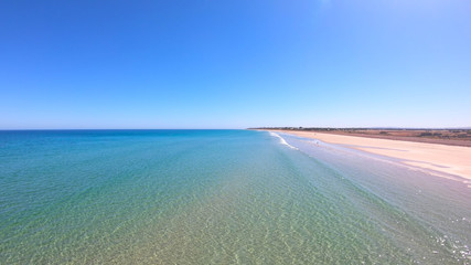 Drone aerial view of Australian wide open beach and coastline, taken at Sellicks Beach, South Australia.