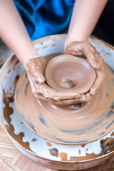 Hands of Experienced Female Potter Working with Clay. Posing with Clay Lump on Potter's Wheel in Workshop.