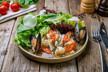 Salad with seafood on a wooden table