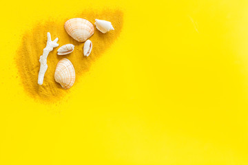 Shells on sand for beach pattern on yellow background top view space for text