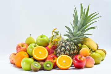 Stacked of tropical fresh fruits on white, Pineapple, Orange, Apple and Kiwi