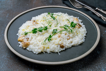 risotto with porcini mushrooms on grey plate