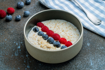 Oatmeal with berries on bowl