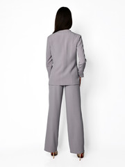 Young beautiful woman manager posing in new casual office suit on a white