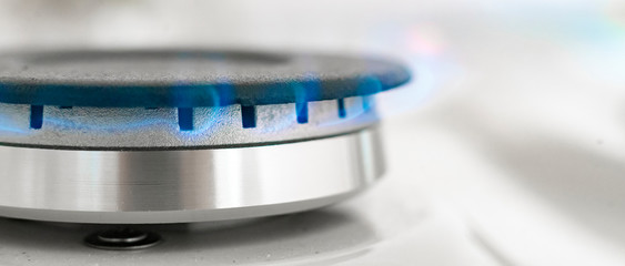 close up macro shot of birning gas ring on light background, natural resources concept