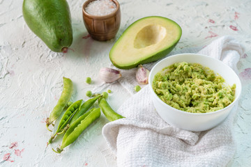 guacamole creamy sauce for toast bread with avocado and peas, mexican food