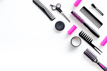 professional pink accessories of hairdresser with combs and sciccors on work desk white background top view copyspace