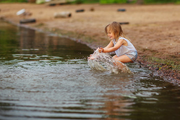 Little girl playing in the lake