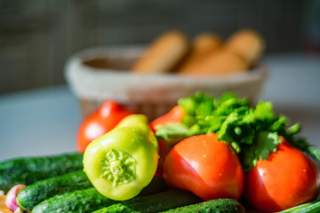 Fresh seasonal vegetables on wooden board on table.