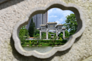 traditional Chinese arch framed by a stone carving Chinese characters translation is harmonious