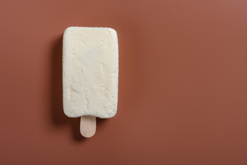 top view fresh milkshake flavor popsicle on a brown background with copy space