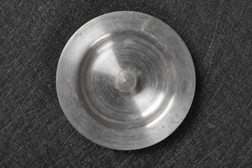 top view metal sink plug on dark background