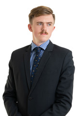 Happy young businessman in suit looking up on white background, isolated concept