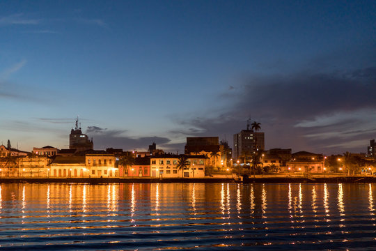 Evening with colourful amazing sunset and light reflection in Itiber&ecirc; river, Paranagu&aacute;, Brazil