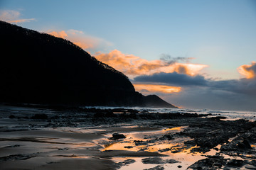 Fototapeta premium Waves and Rocks at Beach at Sunrise