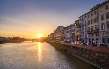 Naklejka na ściany i meble June 6, 2019 - Florence, Italy - A view of Florence, along the Arno River, in the Tuscany region of Italy at sunset.