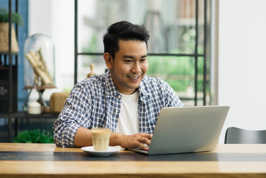 Smart Asian Man Working With Laptop In Cafe, Work Concept And Copy Space.