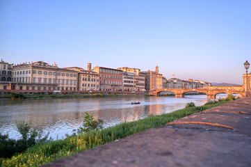 Fototapeta premium June 6, 2019 - Florence, Italy - A view of Florence, along the Arno River, in the Tuscany region of Italy at sunset.