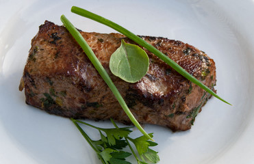 roasted on an open fire steak on a white plate