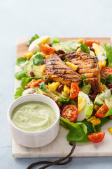 BBQ chicken cobb salad with avocado ranch dressing.