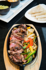 Grilled beef steak with vegetables on dish background. Beef barbecue medium-rare on wood table for food menu. - Image