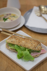 Delicious ham and cheese sandwich on white plate