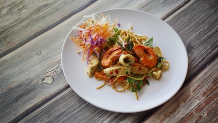 Spicy spaghetti with seafood white plate