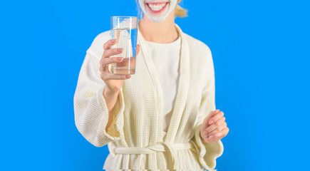 Water balance. Woman bathrobe hold glass of water. Morning habit to drink water. Health care concept. Stay hydrated. Health and beauty. Spa and wellness. Girl care about water balance