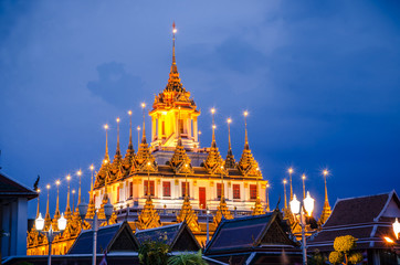 Cityscape Wat Ratchanatdaram Temple the beautiful golden castle or pagoda Bangkok, Thailand in sunset time.