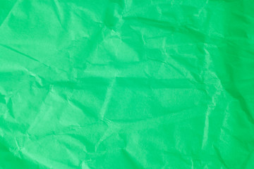 Green crumpled paper background.