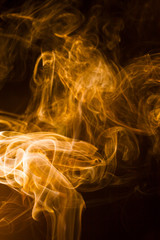 Gold smoke on black background.