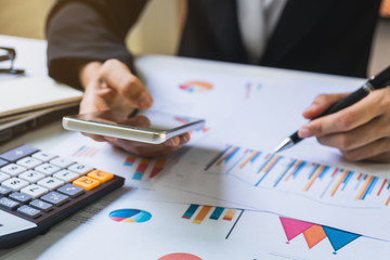 Businesswoman working on Desk office with marketing graph statistics analysis