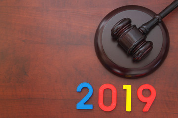 Judge gavel and numbers 2019 with room for text. Concept of new laws in 2019 and changes in court...